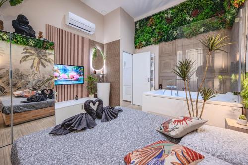 a bedroom with a tub and a bed with pillows at Little Bangkok - Luxury SPA Apartment in Toulon