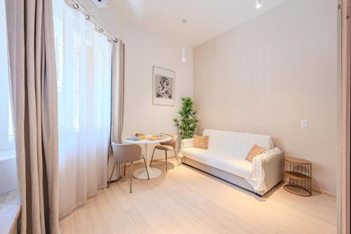 un salon avec un canapé et une table dans l'établissement Little Bangkok - Luxury SPA Apartment, à Toulon