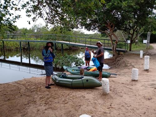 a group of people standing next to a group of canoes at Casa Morada dos Pássaros - 3 suítes in Imbassai