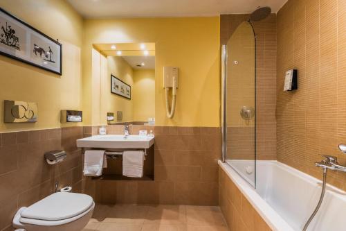 a bathroom with a toilet and a sink and a shower at FH55 Grand Hotel Palatino in Rome