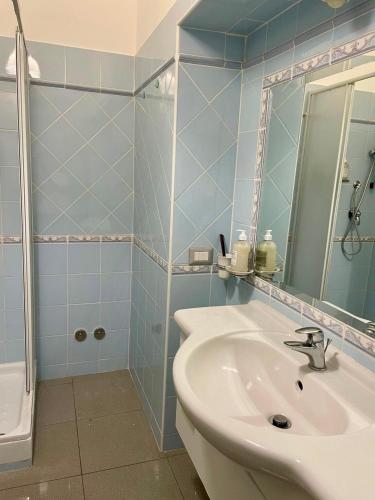 a bathroom with a sink and a mirror and a shower at I Portici Affittacamere in Valmontone
