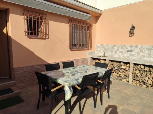 a table and chairs on a patio with a fireplace at VILLA ALTO DE LOS BALCONES Torrevieja - Orihuela Costa in Orihuela