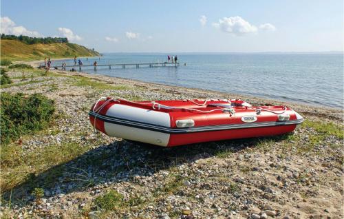 a red and white boat sitting on the beach at Stunning Home In Knebel With Sauna in Knebel