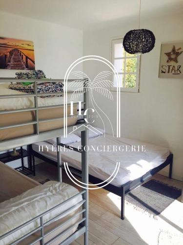 une chambre avec trois lits superposés et une fenêtre dans l'établissement Villa Mont des Oiseaux Piscine Chauffée Clim Vue Mer By HC, à Hyères
