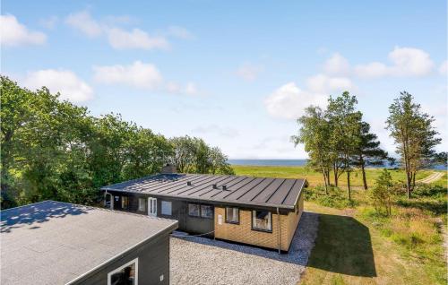 an overhead view of a house with a roof at Cozy Home In Vesløs With House Sea View in Øsløs