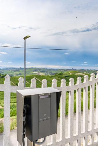 a tv on a white fence with a view at La Grignola Apartments in Canale