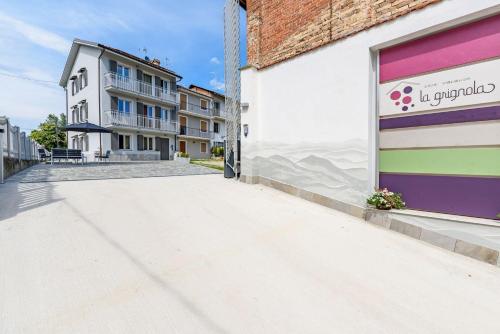 a building with a colorful garage door on a street at La Grignola Apartments in Canale