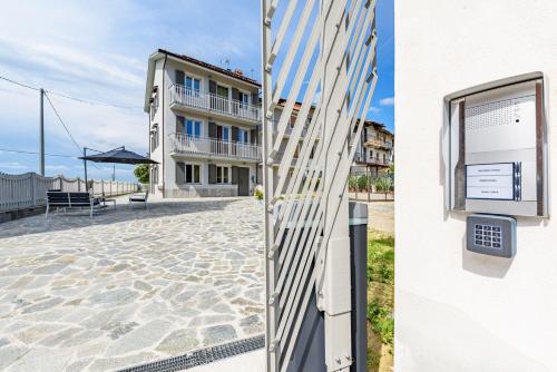 a building with a gate and a building with a patio at La Grignola Apartments in Canale