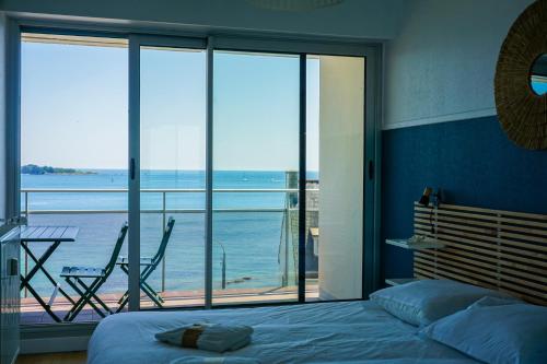 une chambre avec un lit et une vue sur l'océan dans l'établissement -Mave Mai- Magnifique T3 surplombant la mer, à Concarneau