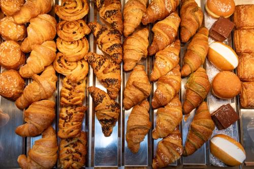 a bunch of croissants and pastries on a display at Hotel Casa Del Pellegrino in Padova