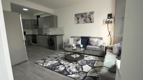 a living room with a couch and a table at LuxuryInn in Wolverhampton