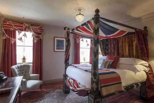 倫敦的住宿－The Zetter Marylebone，一间卧室配有一张天蓬床和一把椅子