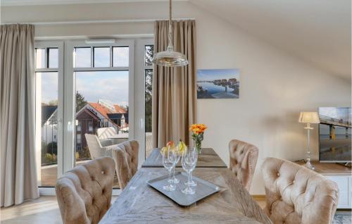 a dining room with a table and chairs and a large window at Baltischer Hof Apartment 66 in Boltenhagen