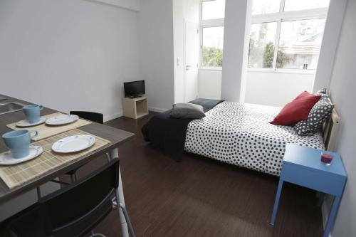 a small room with a bed and a table at Water and Sun Studio in Lisbon