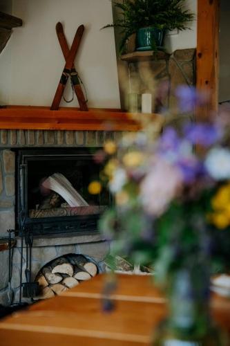 a stone fireplace with a person inside of it at Domek z kominkiem i sauną w górach - Domek Pod Jeziorem in Murzasichle