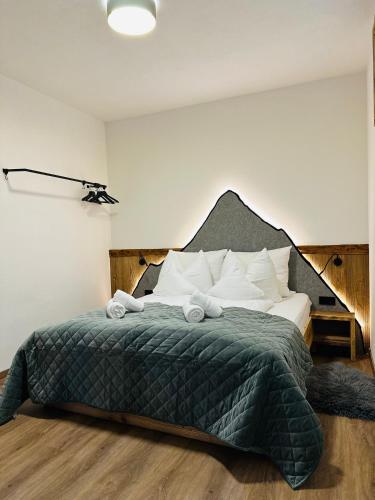 a bedroom with a bed with two towels on it at Chalet Schwarz in Berwang