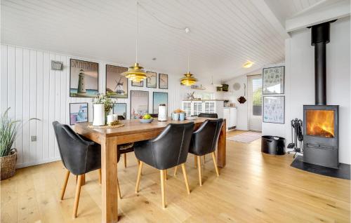 a kitchen and dining room with a wooden table and chairs at 3 Bedroom Awesome Home In Børkop in Børkop