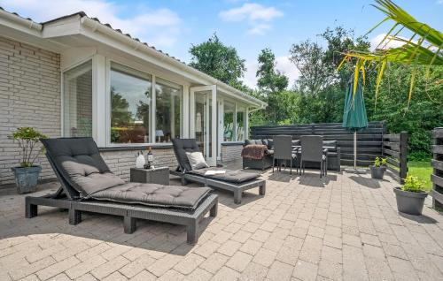 a patio with couches and chairs and an umbrella at Beautiful Home In Slagelse With Kitchen in Slagelse