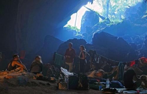 a group of people standing in a cave at Tahan Guest House in Kuala Tahan