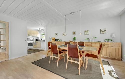 a kitchen and dining room with a table and chairs at Beautiful Home In Slagelse With Kitchen in Slagelse