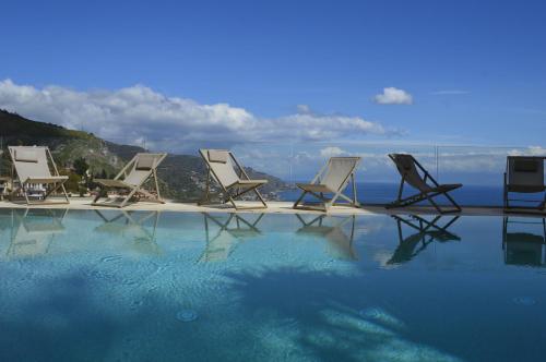 a group of chairs sitting next to a swimming pool at Splendid Hotel Taormina in Taormina