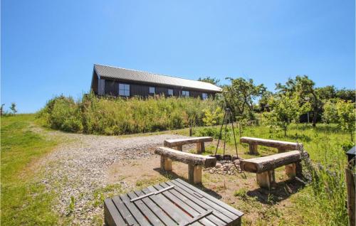 a group of benches in front of a building at 3 Bedroom Gorgeous Home In Samsø in Toftebjerg