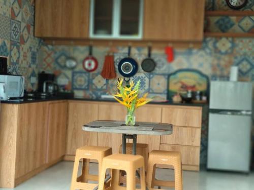 a miniature kitchen with a table and two stools at Villa Kenken - 2 Bedrooms villa close to Keramas Surfing Beach in Keramas