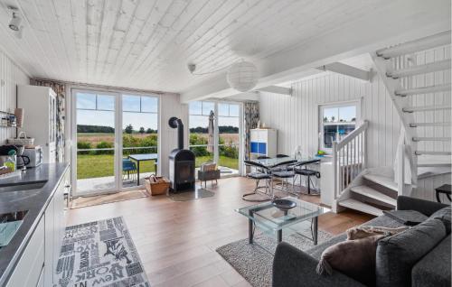 a living room with a couch and a table at 2 Bedroom Cozy Home In Zerpenschleuse in Berg