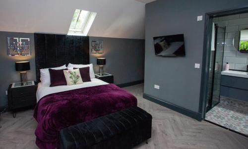 a bedroom with a king sized bed and a large mirror at The Ultimate Luss Retreat in Luss