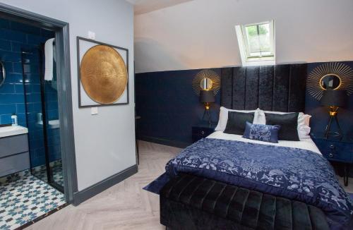 a bedroom with a large bed and a bathroom at The Ultimate Luss Retreat in Luss