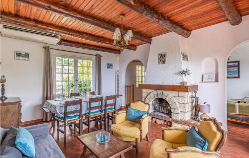 a living room with a fireplace and a table at Amazing Home In Les Adrets-De-L'estére in Les Adrets de l'Esterel