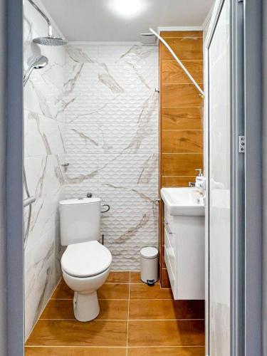 a bathroom with a toilet and a sink at Апартамент Tiana in Tsarevo