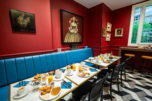 a dining room with two tables with plates of food at Hotel Villa Nicolo - Tour Eiffel in Paris