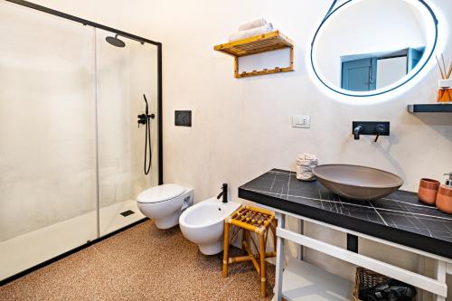 a bathroom with a sink and a toilet and a shower at Loft Poerio Ostuni in Ostuni