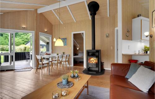 a living room with a couch and a wood stove at Holiday Home Pøt Strandby Juelsminde Ii Dnkm in Sønderby