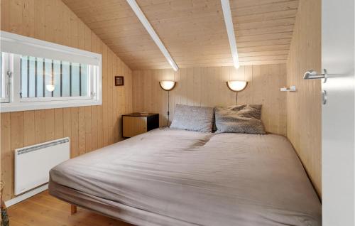 a bedroom with a large bed with two lamps at Holiday Home Pøt Strandby Juelsminde Ii Dnkm in Sønderby