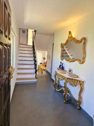 a hallway with a mirror and a table and stairs at Seaside SunFlower in Quinta do Lago