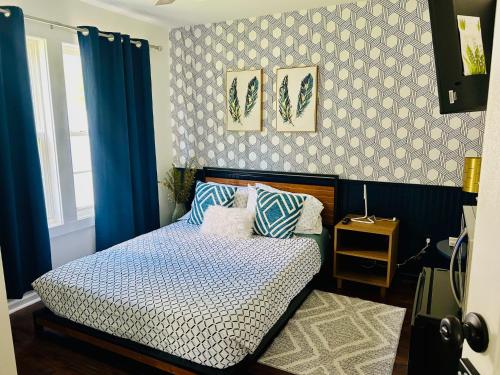 a bedroom with a bed with blue and white sheets at Cozy Bedroom Suites in Beautiful Shared Home in Matthews
