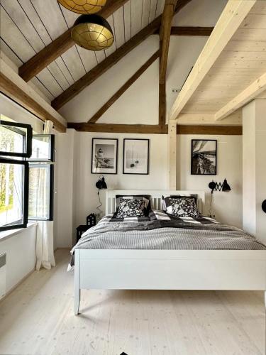 a bedroom with a large white bed in a room at Semtěš 5 in Pšov