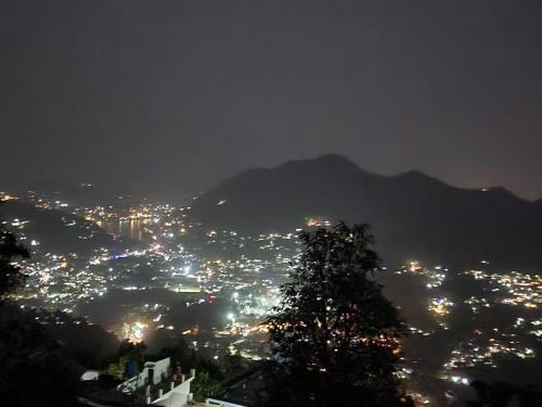 a view of a city lit up at night at Kumaon Lake's Home stay in Nainital