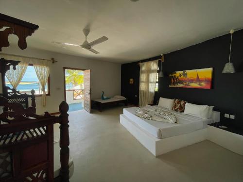 a bedroom with a white bed and a black wall at AVO Boutique Hotel in Dikoni