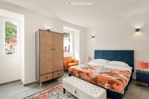 a bedroom with a large bed and a dresser at Pietra Futura, TerreMarine in Pignone