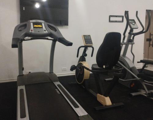 a gym with two exercise bikes and a treadmill at Adam Boutique Eilat in Eilat