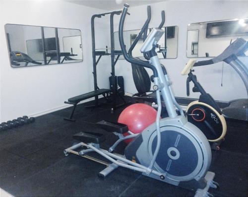 a room with a gym with a exercise bike at Adam Boutique Eilat in Eilat