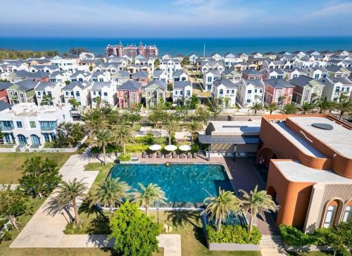 an aerial view of a resort with a swimming pool and houses at Novaworld Beach villa in Phan Thiet
