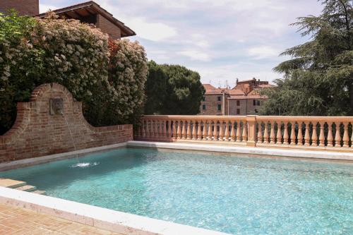 a swimming pool in a yard with a fence at Hotel Vannucci in Città della Pieve