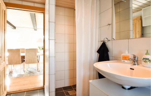 a bathroom with a sink and a mirror at 3 Bedroom Nice Home In Ulfborg in Ulfborg