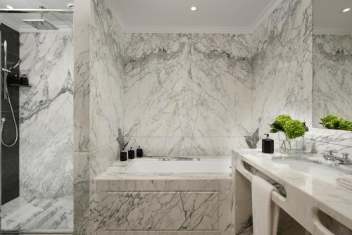 a white bathroom with a tub and two sinks at Parco dei Principi Grand Hotel & SPA in Rome