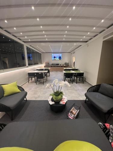 a living room with couches and tables and a television at Al Castello Luxury B&B in Reggio Calabria