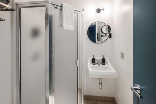 a bathroom with a shower and a sink at Silverbow Inn in Juneau